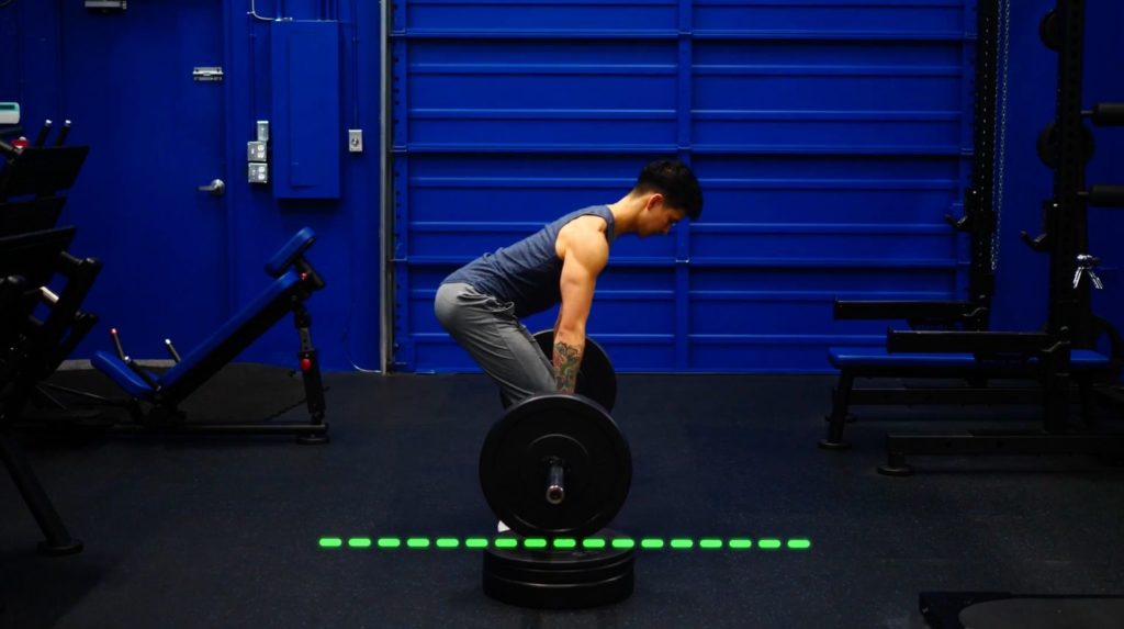 Elevate your weight plates to decrease range of motion