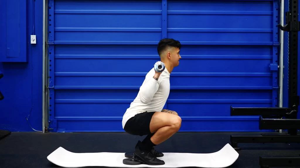 Elevate your heels for greater quads involvement if you have poor ankle mobility