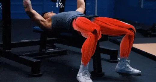Flex your quads and glutes on the bench press to create more stability